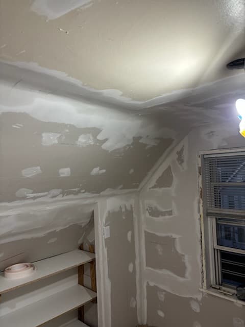 During: taping and skim-coating the sloped ceiling to a Level 4 finish.