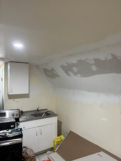 During: taping seams on the sloped ceiling.