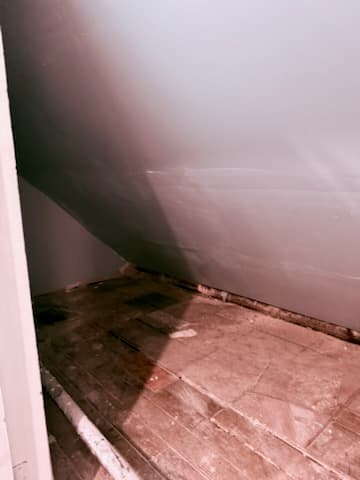 During: hanging drywall over the spray-foam insulation on the sloped ceiling.