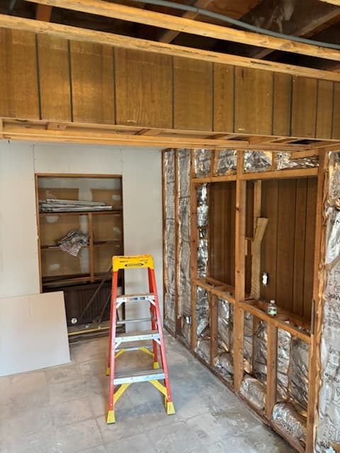 Before: wood paneling coming down and framing exposed in the basement.
