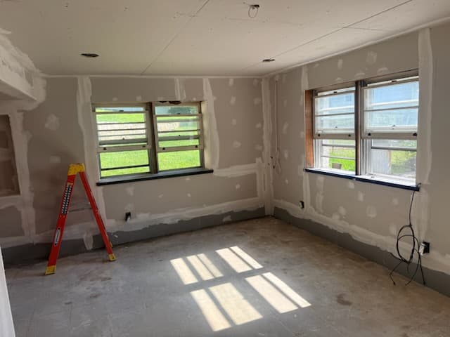 During: basement walls and ceiling taped and coated, drop tiles gone.