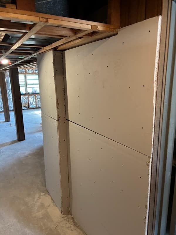 During: the new base plate anchored along a basement wall.
