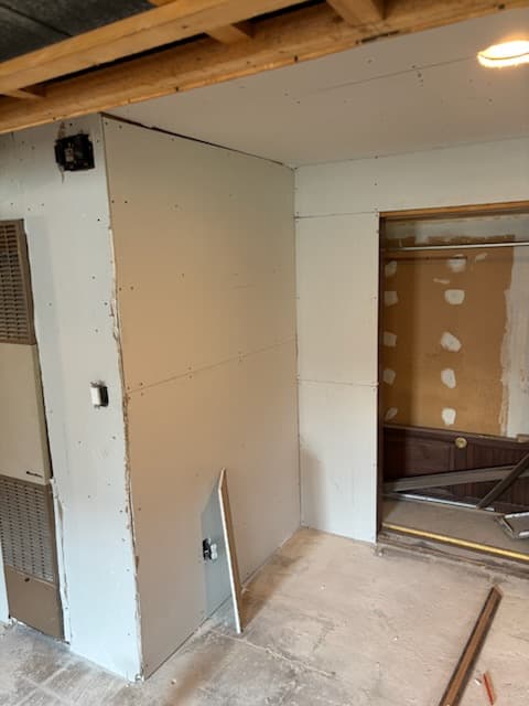 During: spraying orange-peel texture on the basement walls.