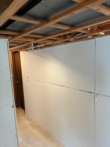 During: new drywall along the basement walls.