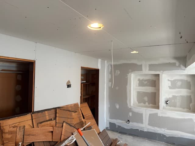 During: hanging new drywall sheets in the basement.