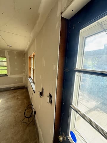 During: taping seams on the new basement drywall.