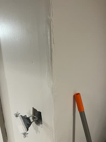 During: mudding seams on the basement walls.