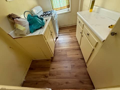 After: new LVP flooring across the kitchen.