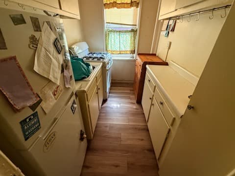 After: finished plank flooring near the bathroom doorway.