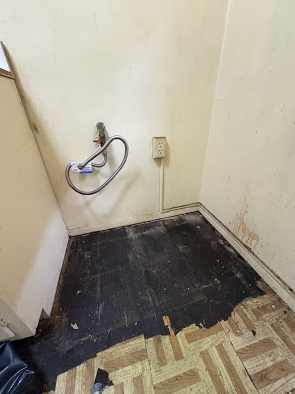 During: subfloor exposed in the kitchen before the new floor went down.